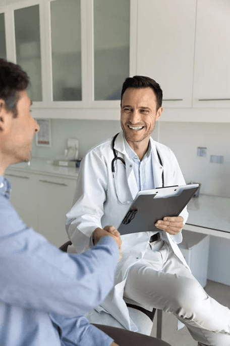 A doctor shaking hands with a patient