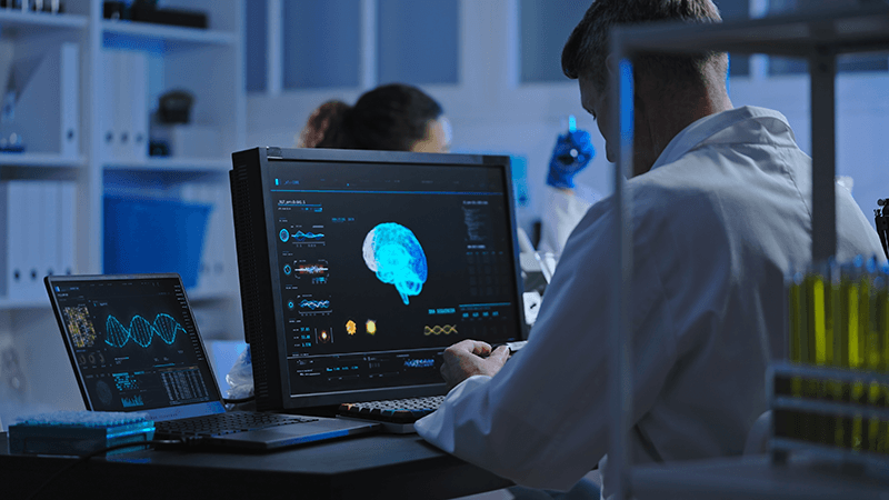 A clinician looking at neurofeedback software in a lab.