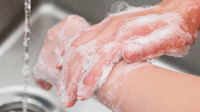 A person with OCD washing their hands.