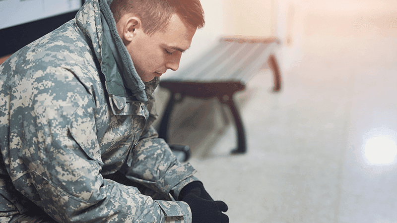 A veteran sitting with his hands clasped.