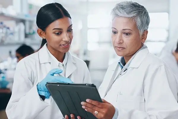 Two scientists looking at a tablet together