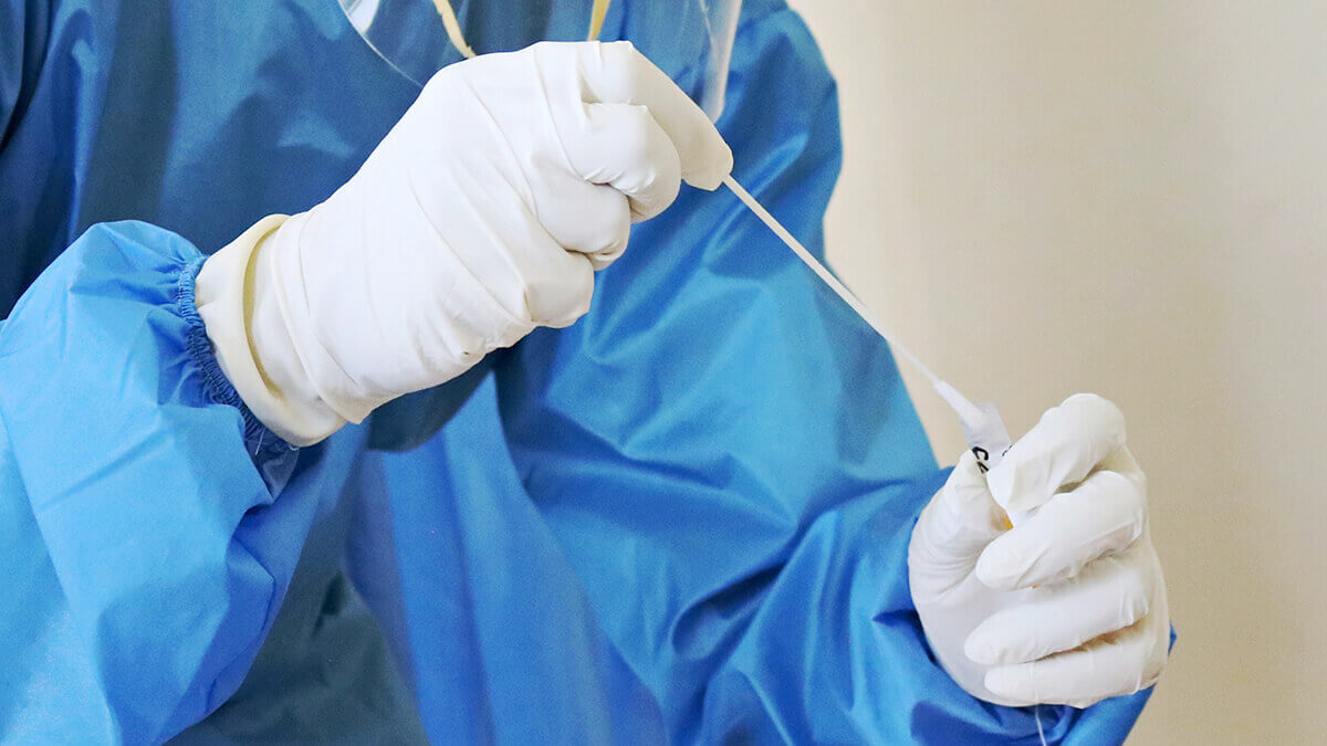 A clinician preparing a swab for a test