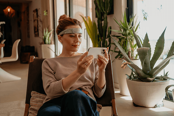 A woman doing neurofeedback at home using an app