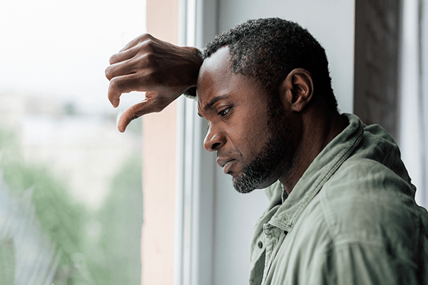A man looking out the window, deep in thought