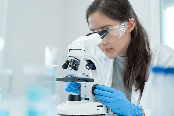 A scientist looking into a microscope